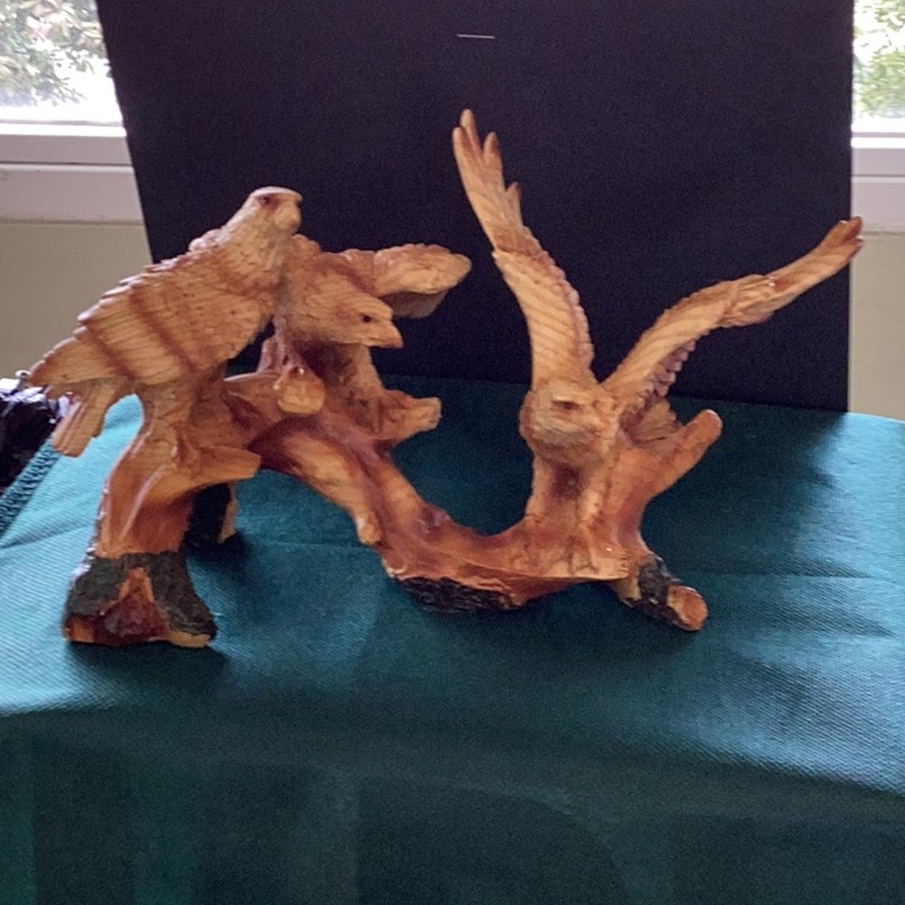 Three eagles perched on branch